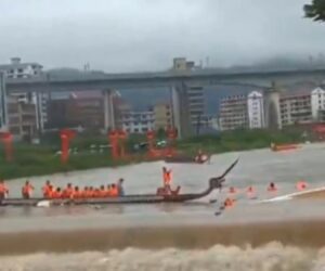 Dragon Boat Swept Over Weir On Rain Swollen River