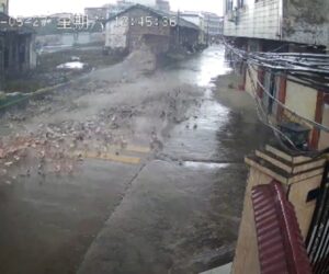 Tricycle Has Lucky Escape As Monsoon Winds Topple Brick Wall On To The Street