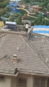 Read more about the article Man Saunters Down Sloped Roof Of Tower Block With No Safety Equipment