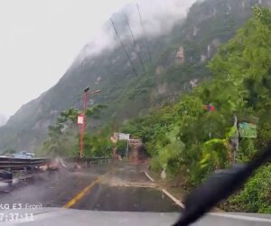 Driver Narrowly Dodges Giant Boulder That Tears Down Trees And Breaks Guardrails