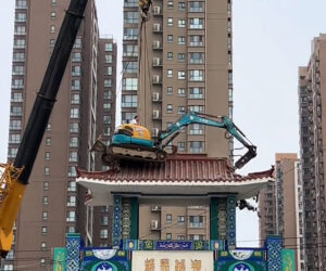 Excavator Operator Hoisted Via Crane To The Top Of 150ft Building Set For Demolition