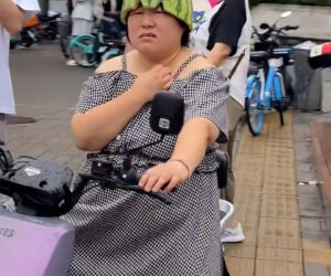 Woman Riding Scooter Uses Half Watermelon For Helmet