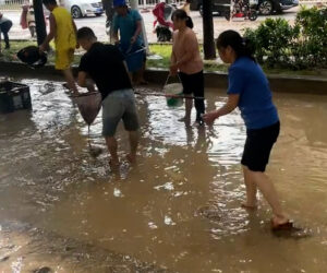  Residents Affected By Typhoon Catch Fish In Flooded Streets