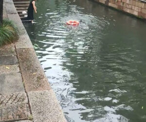 Woman In Black Dress Jumps Into Canal To Save Other Woman’s Life