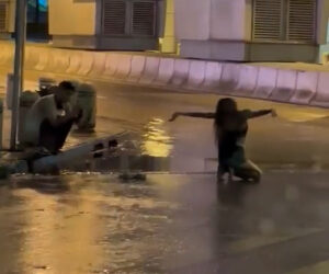 Woman Poses For Photos In The Rain Amid One Of The Most Violent Storms In Decades