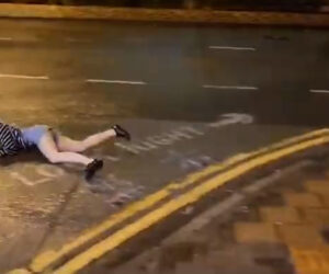 Woman Forced Face-Down Onto The Ground By Strong Winds Amid Powerful Typhoon