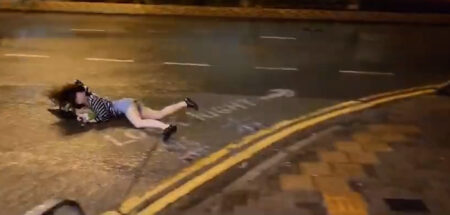 Read more about the article Woman Forced Face-Down Onto The Ground By Strong Winds Amid Powerful Typhoon