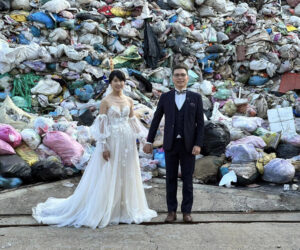 Newlyweds Pose Before Mountain Of Rubbish To Raise Awareness Of Consumer Waste