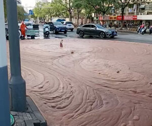 Strange Reddish Liquid Gushing Out From Beneath Road Baffles Residents