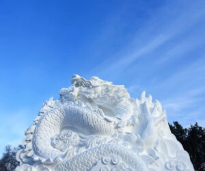 Participants At Winter Festival Carve Massive Dragon Sculpture