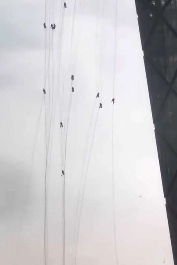 Sudden Storm Leaves Window Cleaners Hanging From Ropes On Chinese Skyscraper